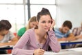 Female student writing notes in classroom Royalty Free Stock Photo