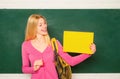 Female student. Young teacher or tutor at classroom in school. Woman education. Student girl holding empty faper for Royalty Free Stock Photo