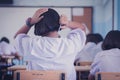 Female students is combing her hair in classroom. Royalty Free Stock Photo