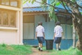 Female Students help to remove rubbish from the classroom Royalty Free Stock Photo