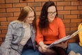 Female students sit in the corridor of the university / university dormitory and teach homework, lectures. The girl explains to