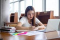Female students sit and do homework Take notes, make reports in the library Royalty Free Stock Photo