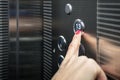 Female in the suit pushing the button it the elevator. Close-up photo of a smart girl, who is an office worker, pushing the lift`