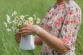 Female in summer park hold bouquet of daisy flowers Royalty Free Stock Photo