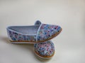 Female summer slippers with a beautiful motley pattern. A pair of beautiful light summer shoes female. Modern summer