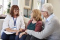 Female Support Worker Visits Senior Couple At Home Royalty Free Stock Photo