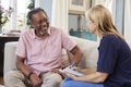 Female Support Worker Visits Senior Man At Home