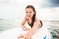 Female surfer paddling on surfboard to the open sea Royalty Free Stock Photo