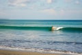 Female surfer riding a beginner wave in Bali