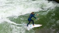 Athletic Female Surfing the Eisbachwelle in Munich Germany