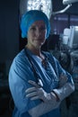 Female surgeon with arms crossed looking at camera in operating room Royalty Free Stock Photo