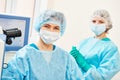 Female surgeon with assistant in ophthalmological operation room Royalty Free Stock Photo