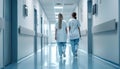 Female Surgeon and Doctor Walk Through White Hospital Hallway