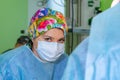 Female surgeon doctor wearing protective mask and hat during the operation. Healthcare, medical education, emergency Royalty Free Stock Photo