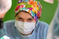 Female surgeon doctor wearing protective mask and hat during the operation. Healthcare, medical education, emergency Royalty Free Stock Photo