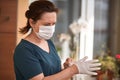 Female surgeon or nurse wearing a sterile suit putting on sterile rubber gloves to perform a surgery Royalty Free Stock Photo