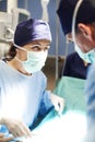 Female surgeon over operating table