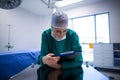 Female surgeon reading reports in operation theater Royalty Free Stock Photo