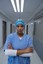 Female surgeon sitting with arms crossed in the corridor of hospital Royalty Free Stock Photo