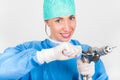 Female surgeon smiling, holding antique, old fashioned medical drill