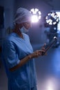 Female surgeon using digital tablet in operation room Royalty Free Stock Photo