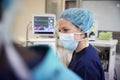 Female Surgical Team Member Working On Patient In Hospital Operating Theatre Royalty Free Stock Photo