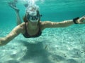 Female swimmer blowing bubbles under water