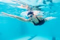 Female swimmer gushing through water in pool