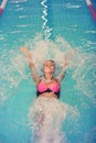 A female swimmer in indoor sport swimming pool. smiling girl in pink sweimsuit Royalty Free Stock Photo