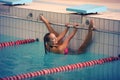 A female swimmer in indoor sport swimming pool. smiling girl in pink sweimsuit