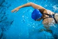 Female swimmer in an indoor swimming pool - doing crawl Royalty Free Stock Photo