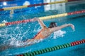 Female swimmer moving through the water performs a butterfly stroke Royalty Free Stock Photo