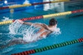 Female swimmer moving through the water performs a butterfly stroke Royalty Free Stock Photo