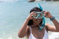 Female Swimmer Smiling And Putting On Snorkeling Goggles