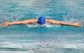 Female swimmer is swimming in butterfly stroke during competition Royalty Free Stock Photo