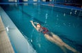 Female swimmer swimming on her back in pool Royalty Free Stock Photo