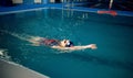 Female swimmer swimming on her back in pool Royalty Free Stock Photo