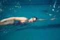 Female swimmer swimming on her back in pool Royalty Free Stock Photo