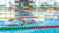 Female swimmer using freestyle technique in pool lane Royalty Free Stock Photo