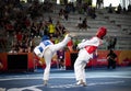 Female taekwondo fighter kick during match