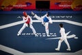 Female taekwondo fighter kick during match Royalty Free Stock Photo