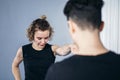 Female taekwondo instructor conducts personal training session for young woman at gym. Girl mastering new taekwondo moves during Royalty Free Stock Photo