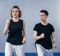 Female taekwondo instructor conducts personal training session for young woman at gym. Girl mastering new taekwondo moves during Royalty Free Stock Photo