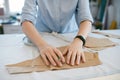 Female Tailor Making Sewing Patterns On Table