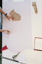 Female Tailor Making Sewing Patterns On Table