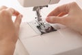 Female tailor threading sewing machine, closeup Royalty Free Stock Photo