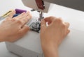 Female tailor threading sewing machine, closeup Royalty Free Stock Photo