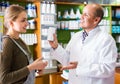 Female talking to a pharmacist Royalty Free Stock Photo