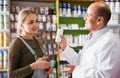 Female talking to a pharmacist Royalty Free Stock Photo