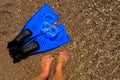 Female tanned legs, fins and mask on the beach, sea vacation concept. Royalty Free Stock Photo